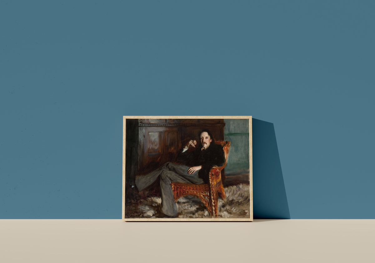 Framed art print of Robert Louis Stevenson by John Singer Sargent, in a light wood frame leaning on a blue wall