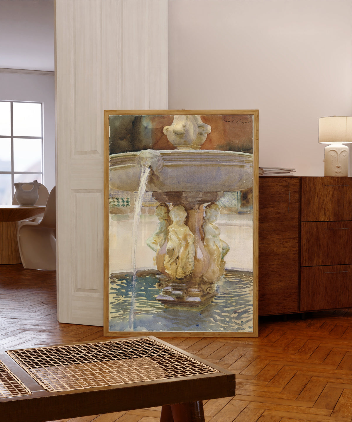 Framed art print of Spanish Fountain by John Singer Sargent, in a light wood frame leaning in a warm room with a parquet floor