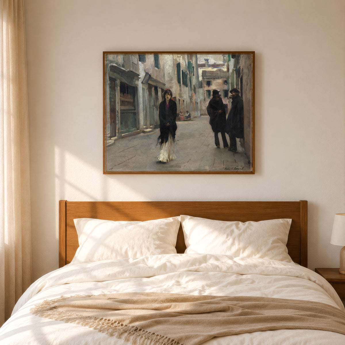 Framed art print of Street in Venice (Woman in a Black Shawl) by John Singer Sargent, in a slim wood frame above a bed in a sunlit bedroom
