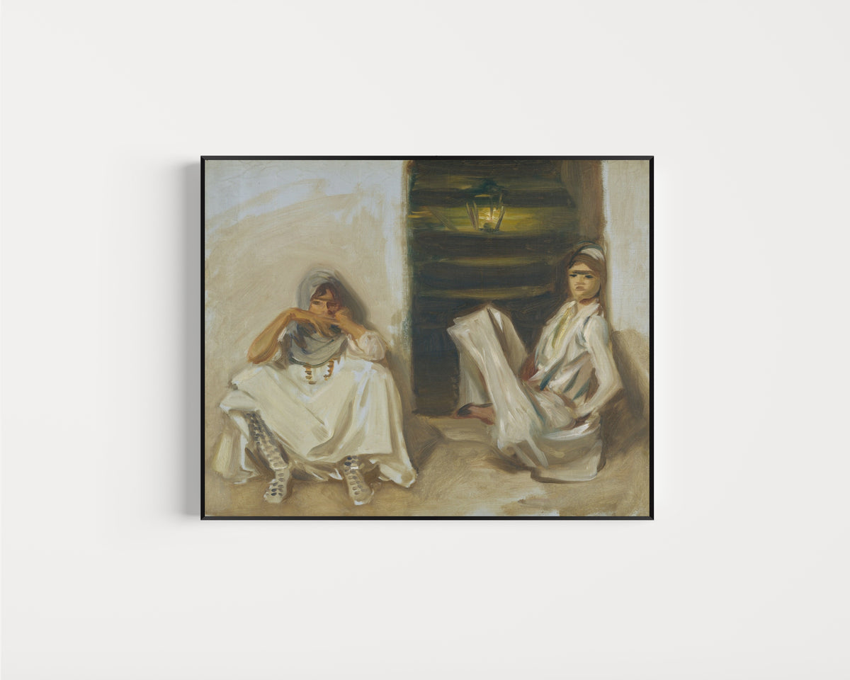 Framed art print of Two Arab Women by John Singer Sargent, in a slim black frame on a plain white wall