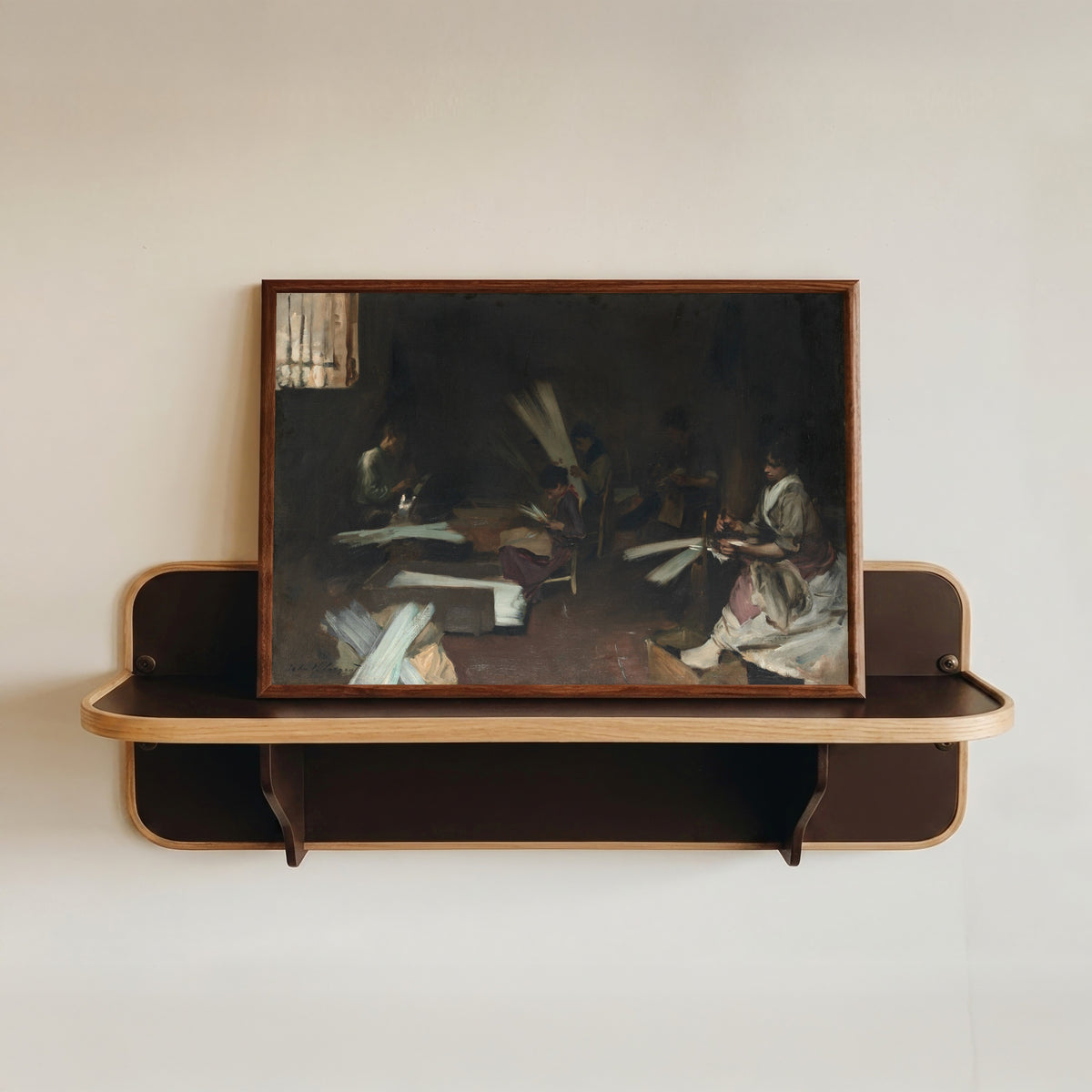 Framed art print of Venetian Glass Workers by John Singer Sargent, in a dark wood frame resting on a wall shelf