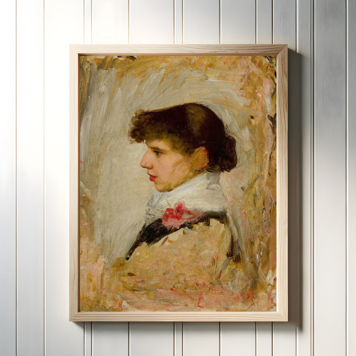 Framed art print of Head of a Model by John William Waterhouse, in a light wood frame on a white panelled wall