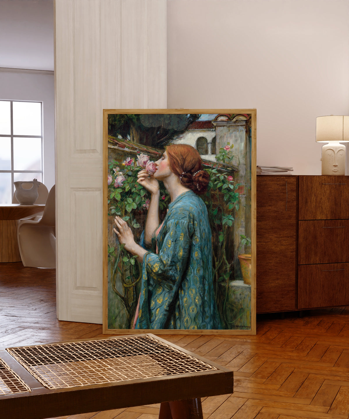 Framed art print of The Soul of the Rose by John William Waterhouse, in a light wood frame leaning in a warm room with a parquet floor