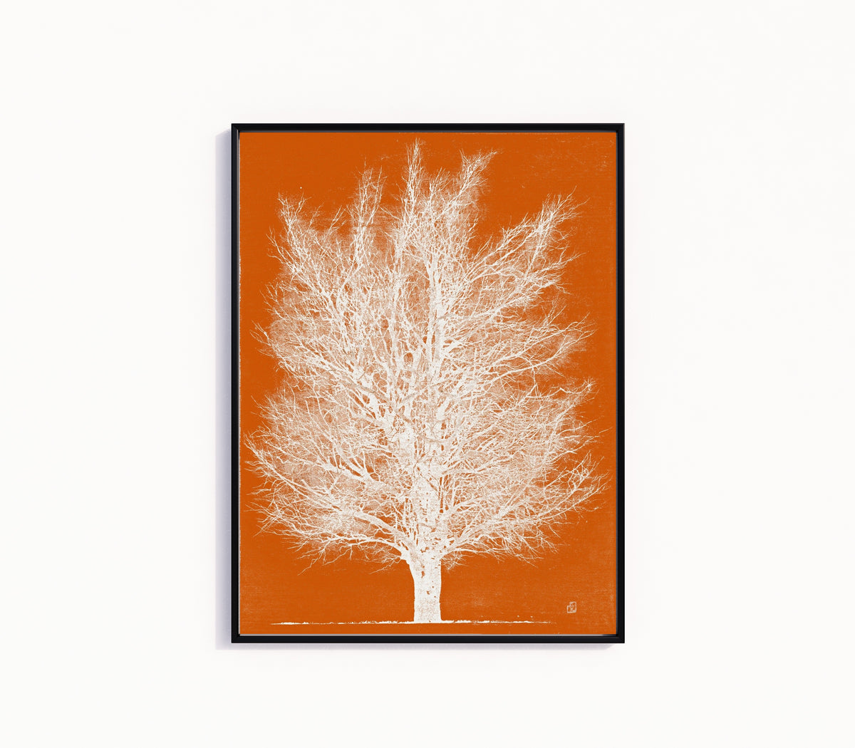 Framed art print of Orange and White Tree by Joichi Hoshi, in a slim black frame on a plain white wall