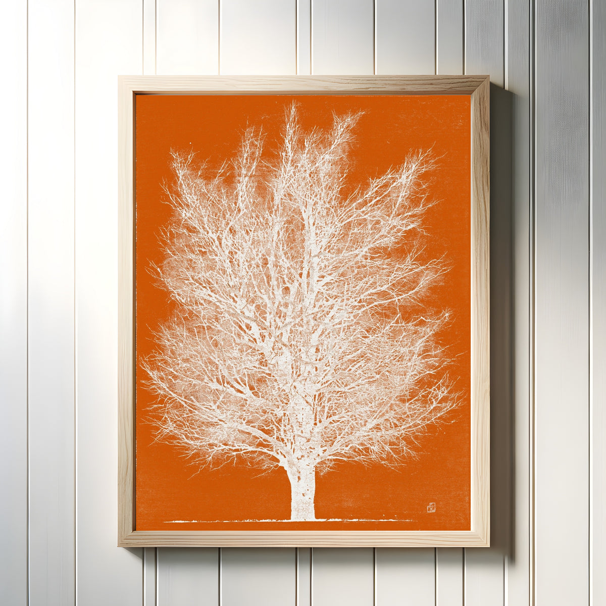 Framed art print of Orange and White Tree by Joichi Hoshi, in a light wood frame on a white panelled wall