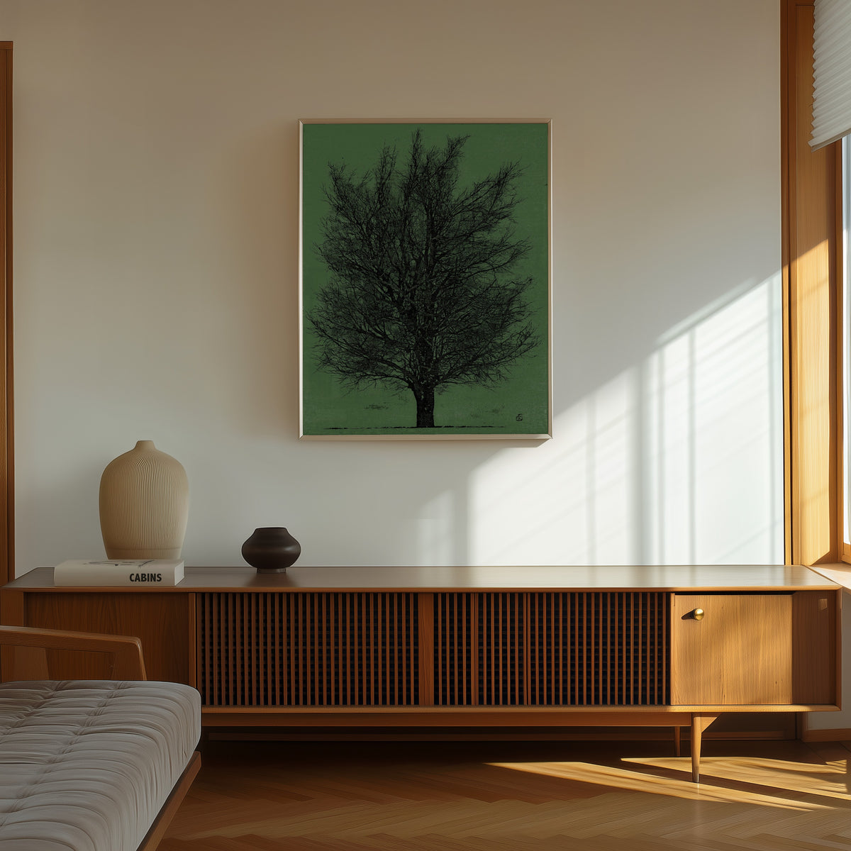 Framed art print of Tree in Black and Green by Joichi Hoshi, in a thin light frame on a sunlit wall above a wooden sideboard