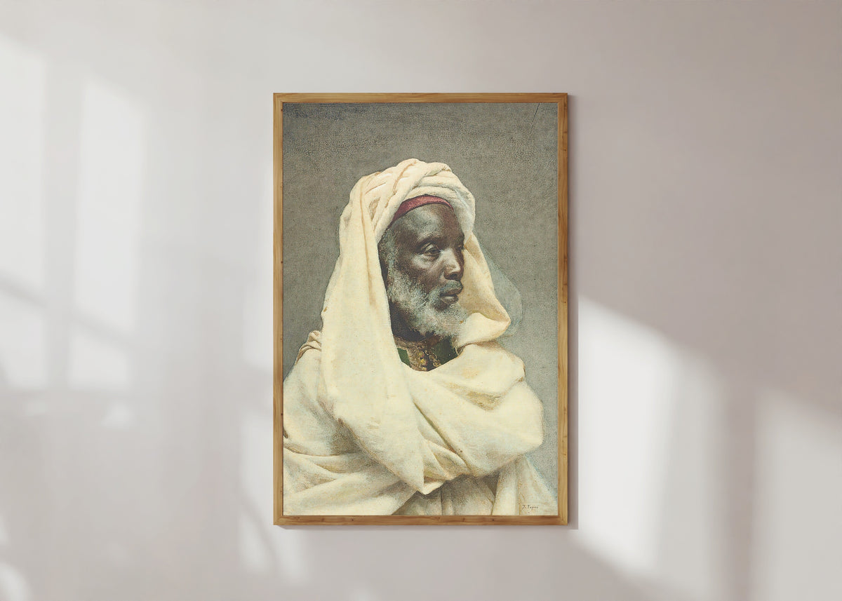 Framed art print of Moorish Elder by Josep Tapiró Baró, in a light wood frame on a sunlit white wall