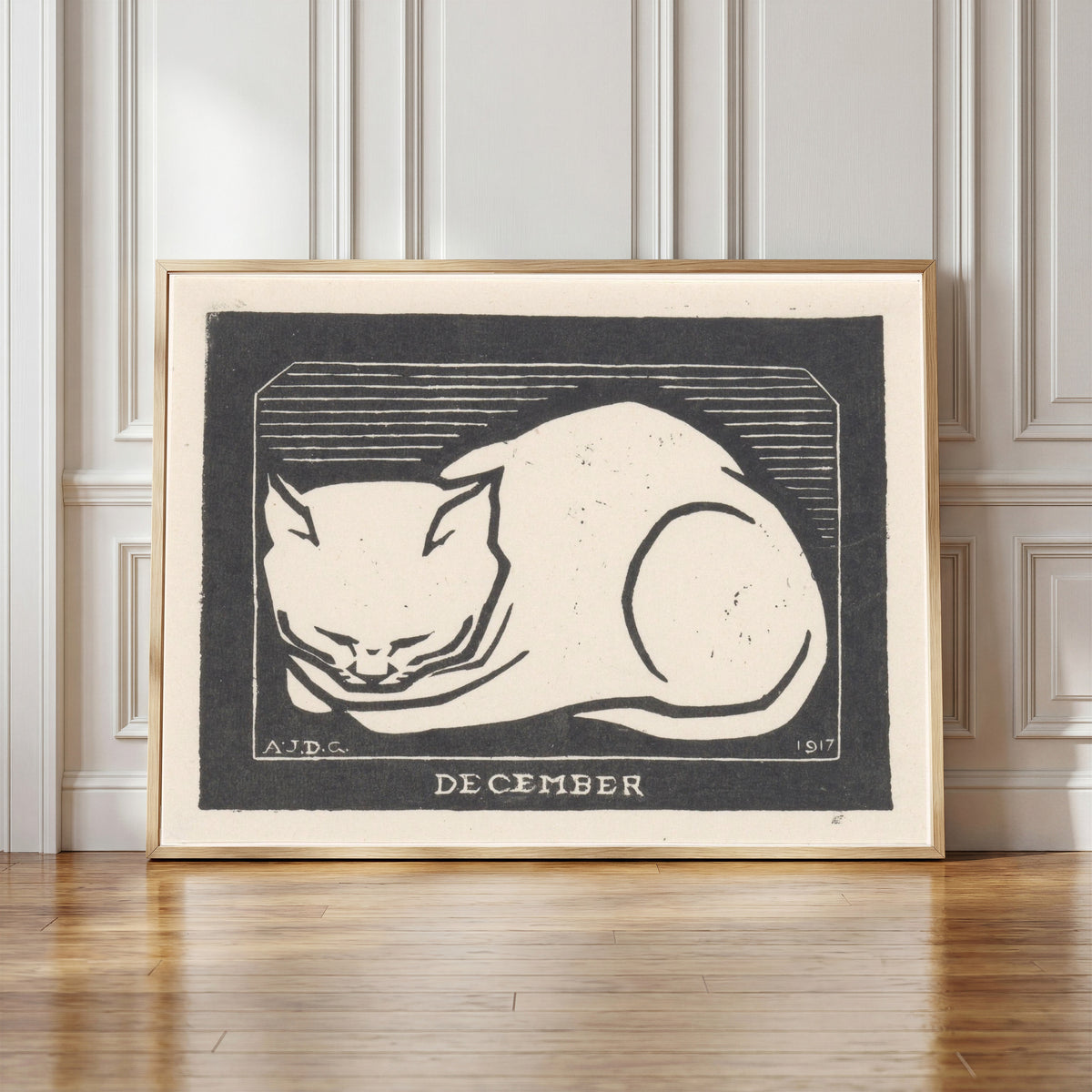 Framed art print of December by Julie de Graag, in a light wood frame leaning against a panelled white wall