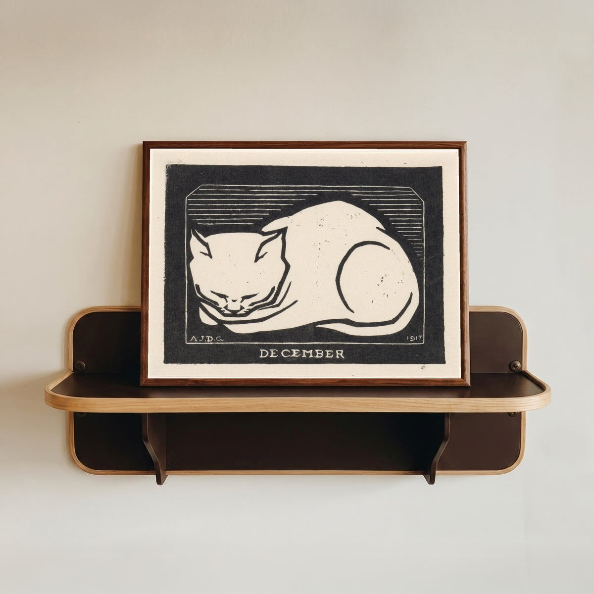 Framed art print of December by Julie de Graag, in a dark wood frame resting on a wall shelf