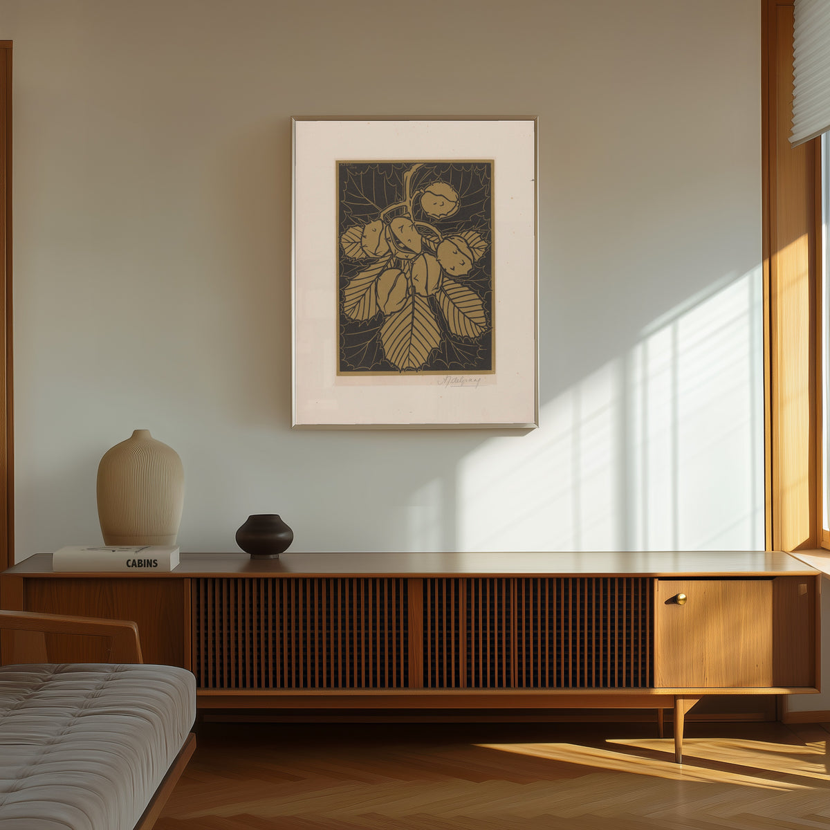 Framed art print of Hazelnuts and leaves by Julie de Graag, in a thin light frame on a sunlit wall above a wooden sideboard