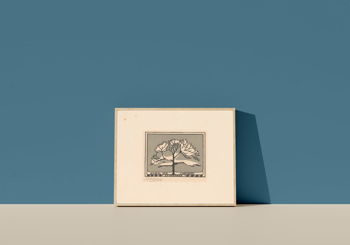 Framed art print of January by Julie de Graag, in a light wood frame leaning on a blue wall