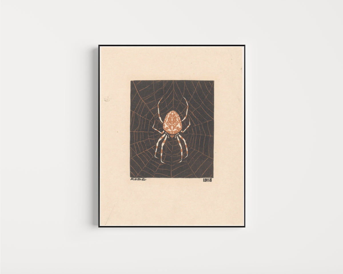 Framed art print of Spider in web by Julie de Graag, in a slim black frame on a plain white wall