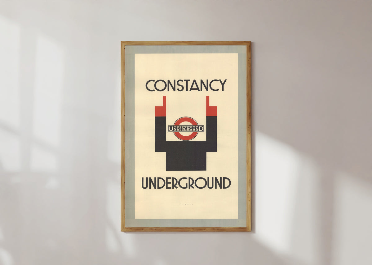 Framed art print of Constancy (London Underground) by Julius Klinger, in a light wood frame on a sunlit white wall