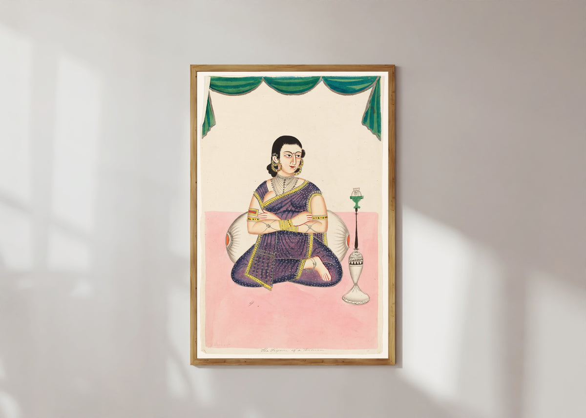 Framed art print of Portrait of a Woman by Kalighat painter, in a light wood frame on a sunlit white wall