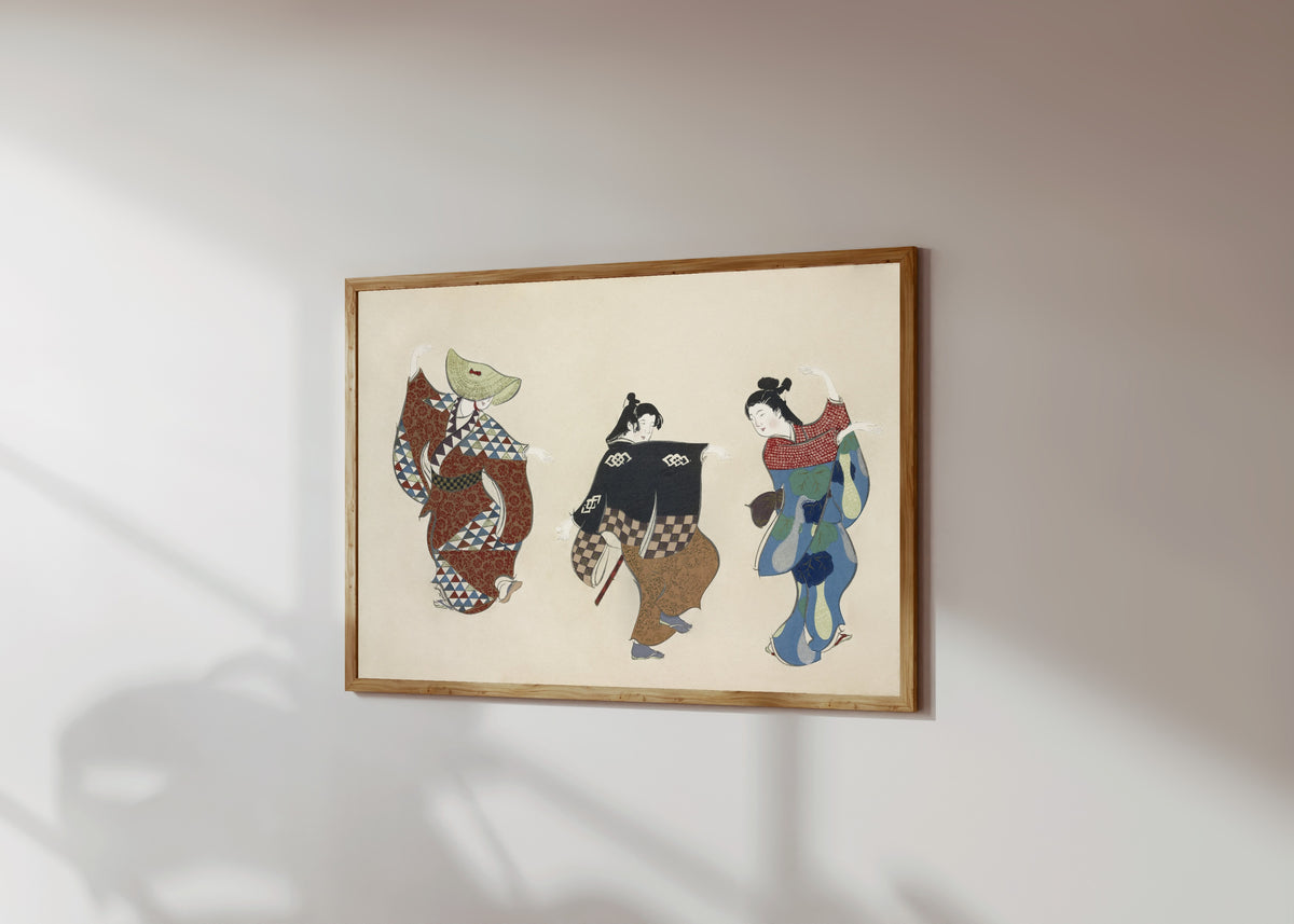 Framed art print of Dancers, from Momoyogusa by Kamisaka Sekka, in a light wood frame on a sunlit white wall, seen at a slight angle