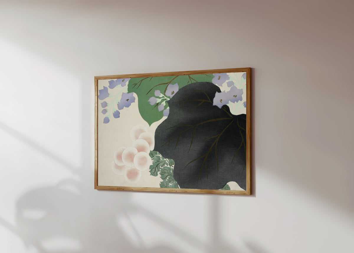 Framed art print of Flowers and leaves, from Momoyogusa by Kamisaka Sekka, in a light wood frame on a sunlit white wall, seen at a slight angle
