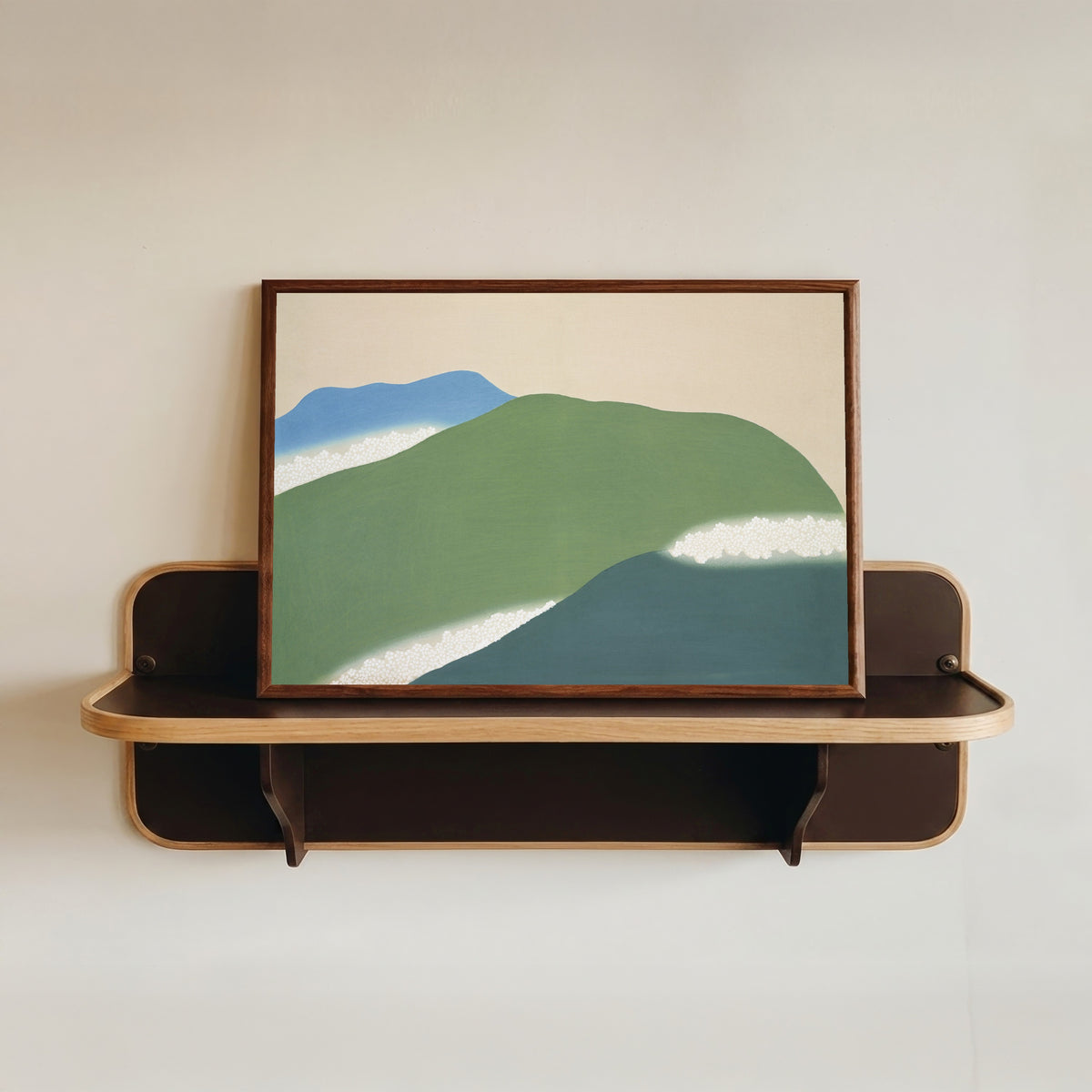 Framed art print of Green mountains, from Momoyogusa by Kamisaka Sekka, in a dark wood frame resting on a wall shelf