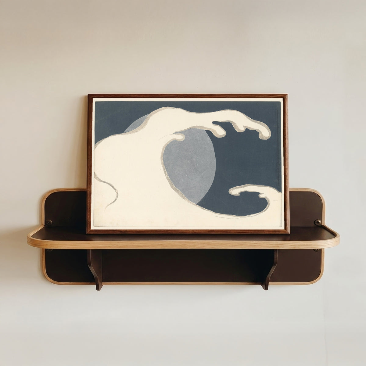 Framed art print of High Wave (Hoge golf) by Kamisaka Sekka, in a dark wood frame resting on a wall shelf