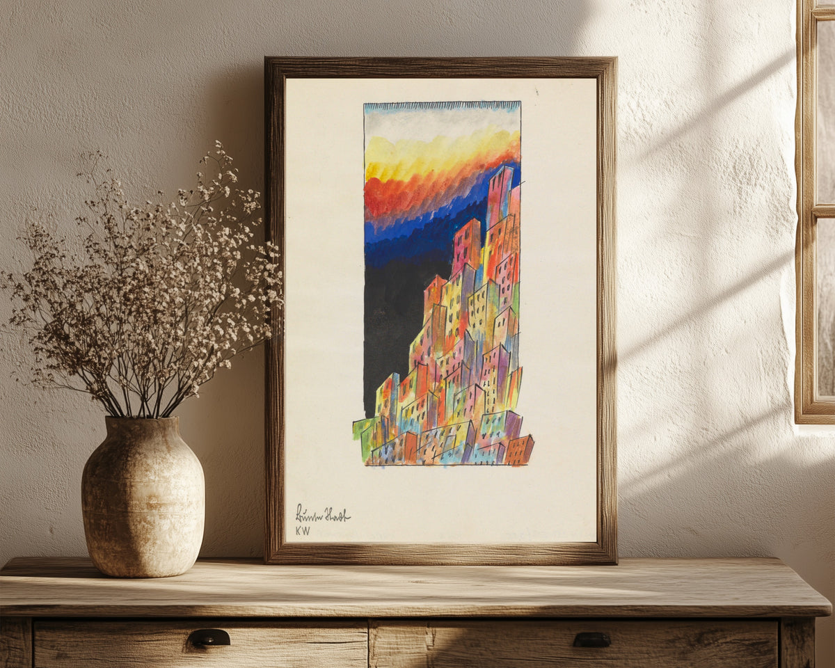 Framed art print of Bunte Stadt (Colourful City, Towers) by Karl Wiener, in a dark wood frame leaning on a rustic console beside dried flowers