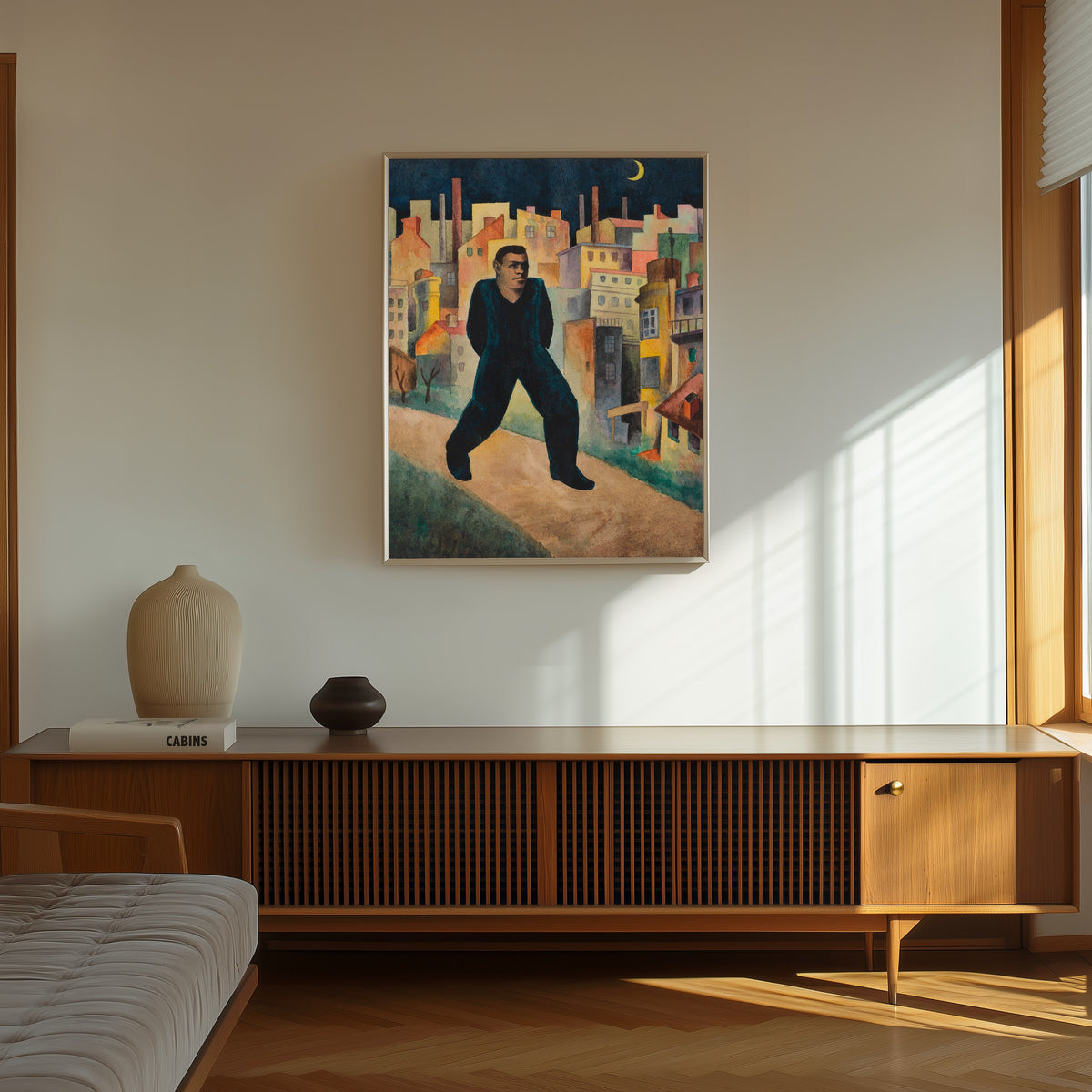 Framed art print of In Memoriam Trakl by Karl Wiener, in a thin light frame on a sunlit wall above a wooden sideboard