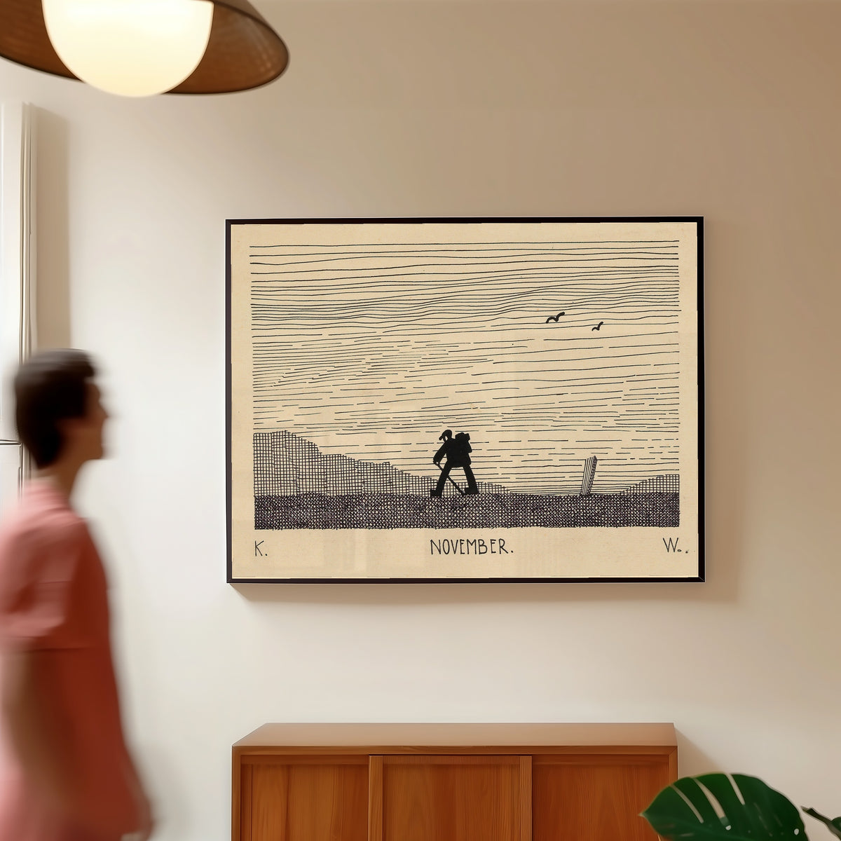 Framed art print of November by Karl Wiener, in a slim black frame on a warm wall in a sunlit room