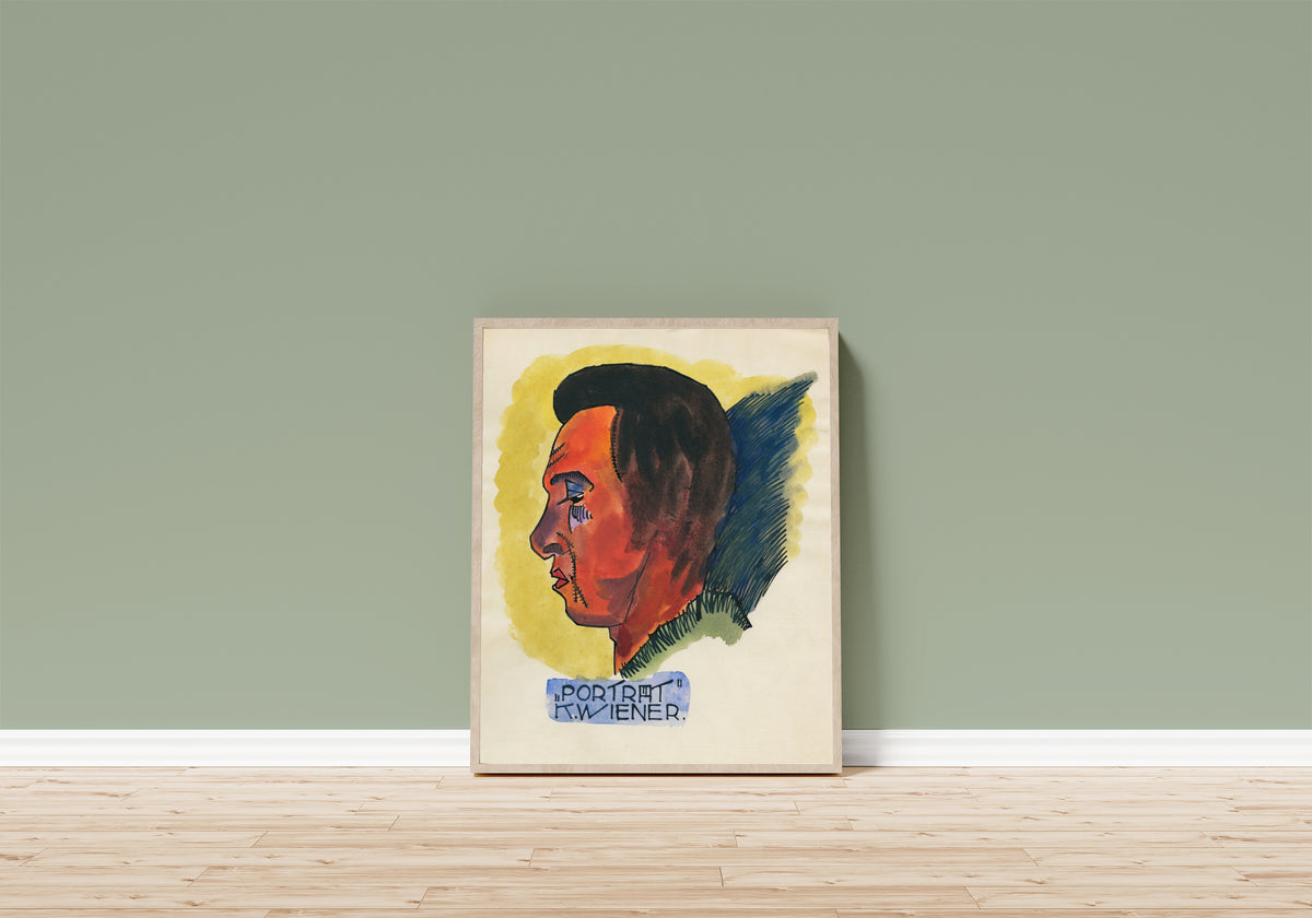 Framed art print of Porträt (Portrait in Profile) by Karl Wiener, in a light wood frame leaning on a sage green wall above a wooden floor