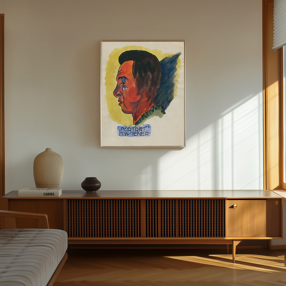 Framed art print of Porträt (Portrait in Profile) by Karl Wiener, in a thin light frame on a sunlit wall above a wooden sideboard