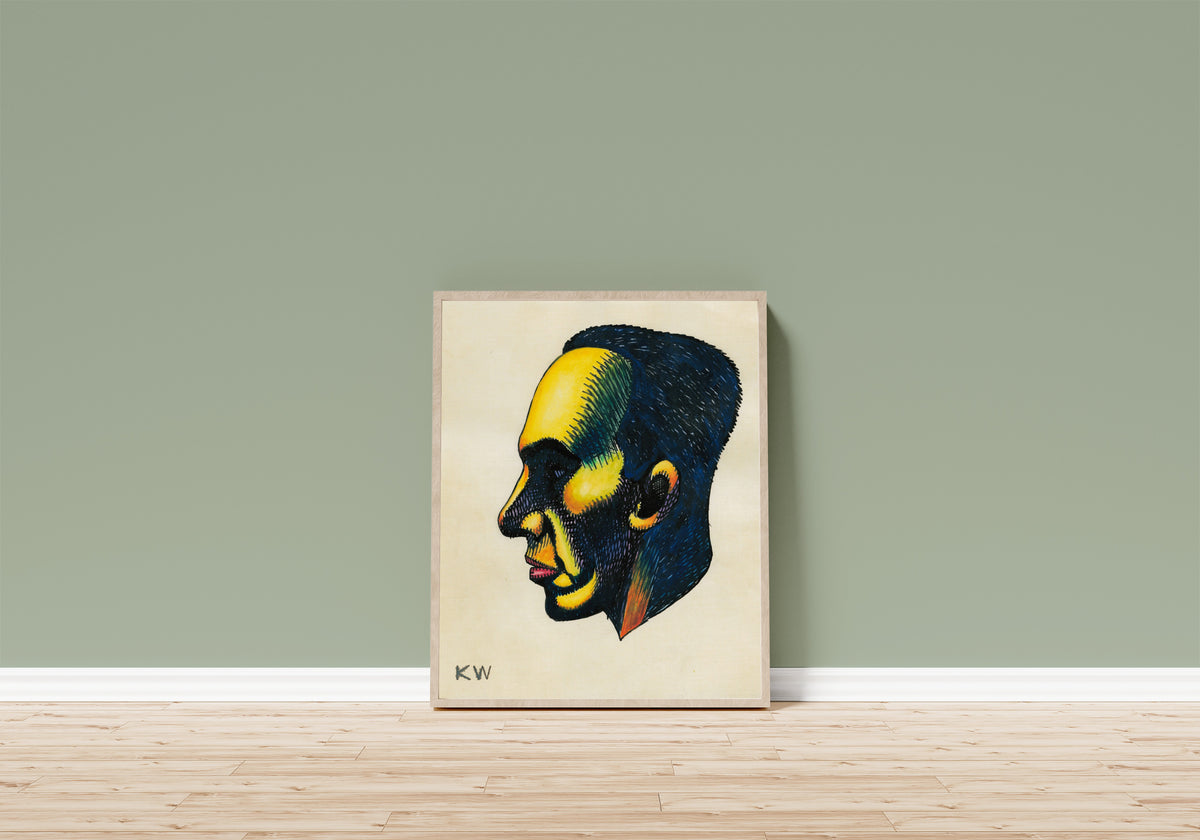 Framed art print of Profile Head Study No. 1 by Karl Wiener, in a light wood frame leaning on a sage green wall above a wooden floor