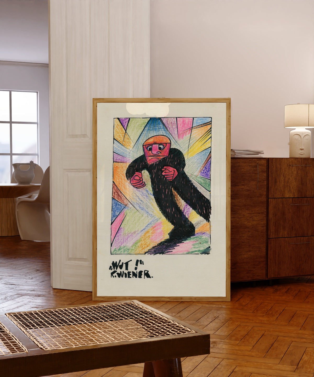 Framed art print of Wut! (Rage!) by Karl Wiener, in a light wood frame leaning in a warm room with a parquet floor
