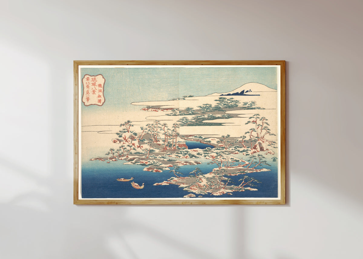 Framed art print of Eight Views of the Ryūkyū Islands: Pines and Waves at Ryūtō by Katsushika Hokusai, in a light wood frame on a sunlit white wall