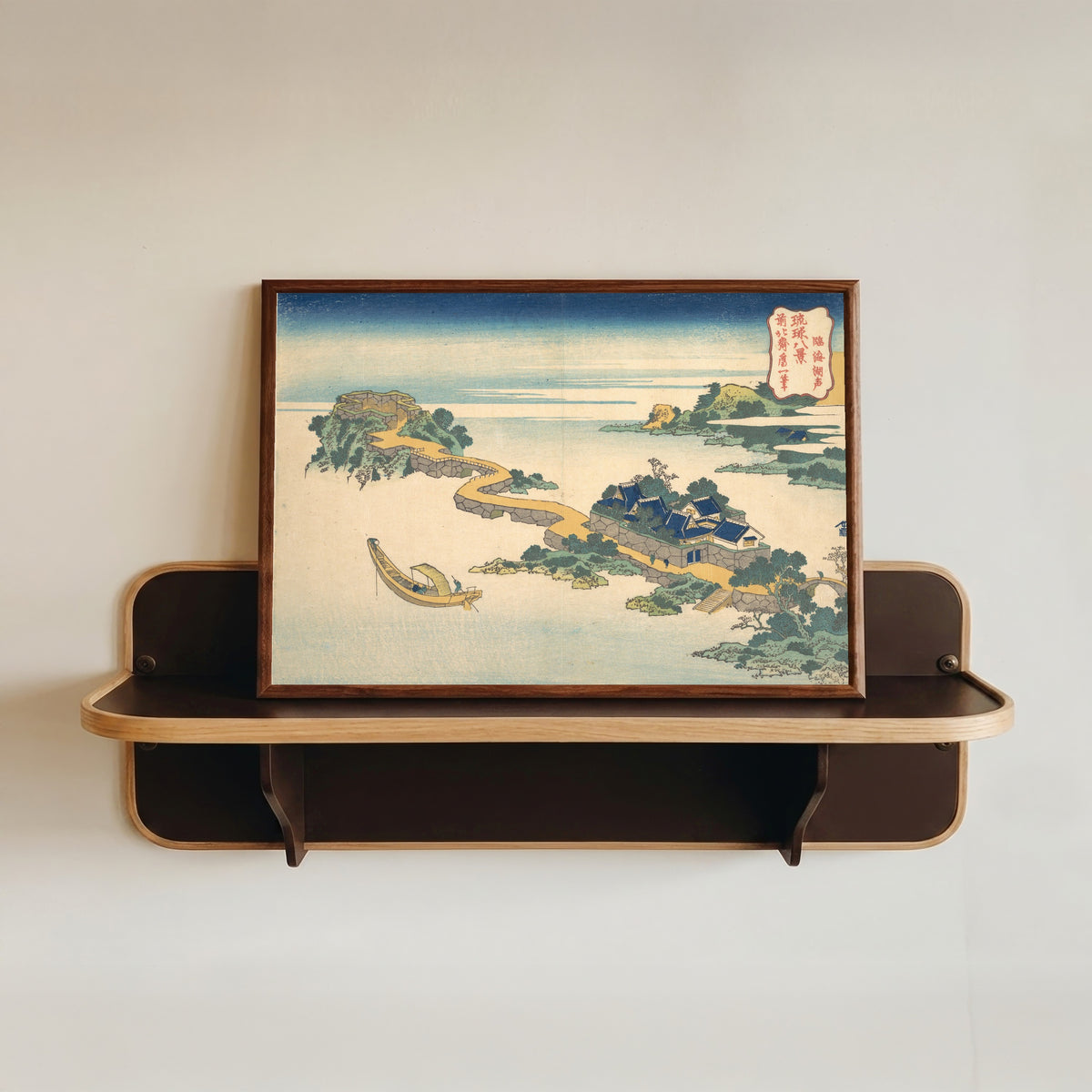 Framed art print of Eight Views of the Ryūkyū Islands: Sound of the Lake at Rinkai by Katsushika Hokusai, in a dark wood frame resting on a wall shelf