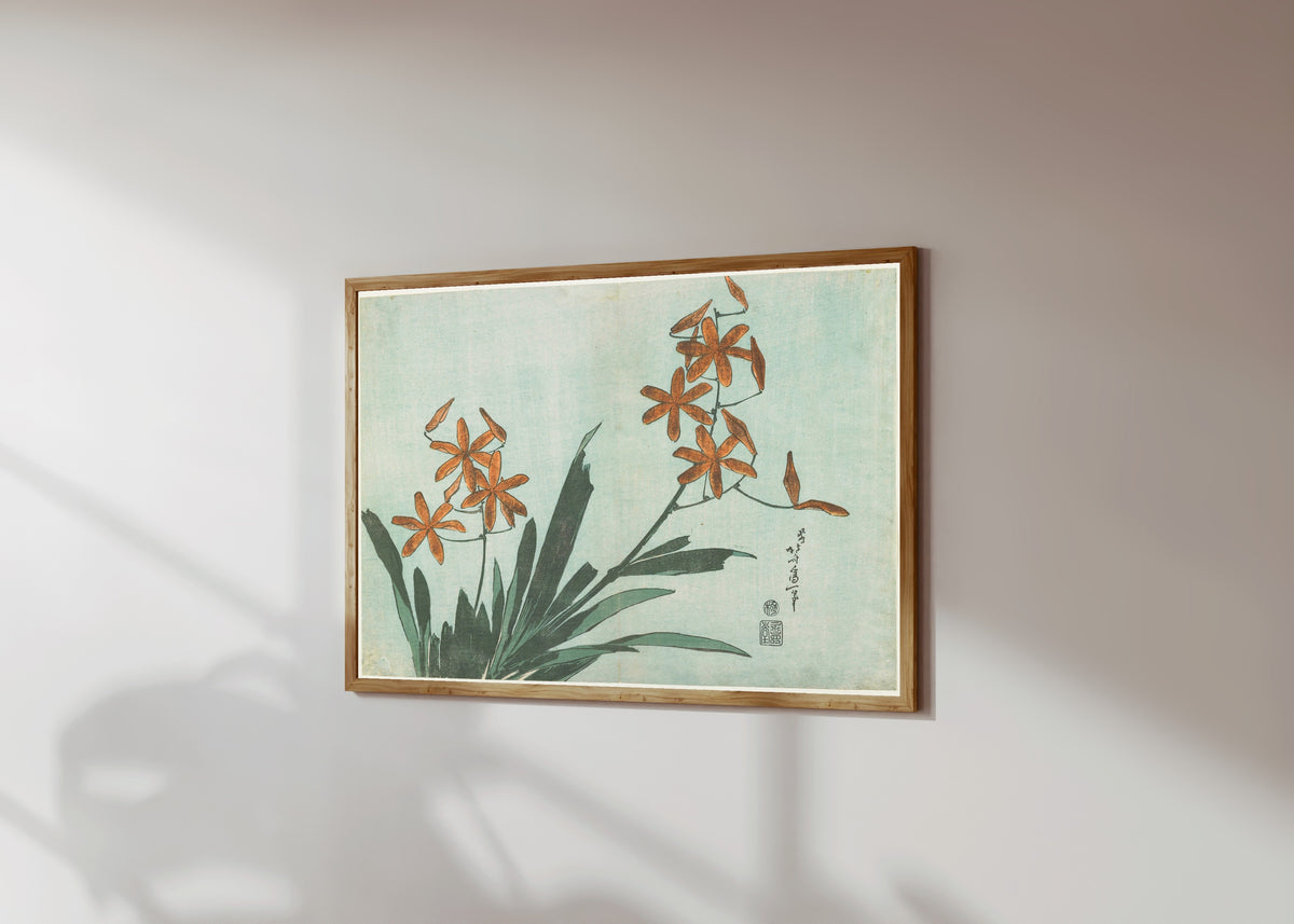 Framed art print of Large Flowers: Leopard Lily by Katsushika Hokusai, in a light wood frame on a sunlit white wall, seen at a slight angle
