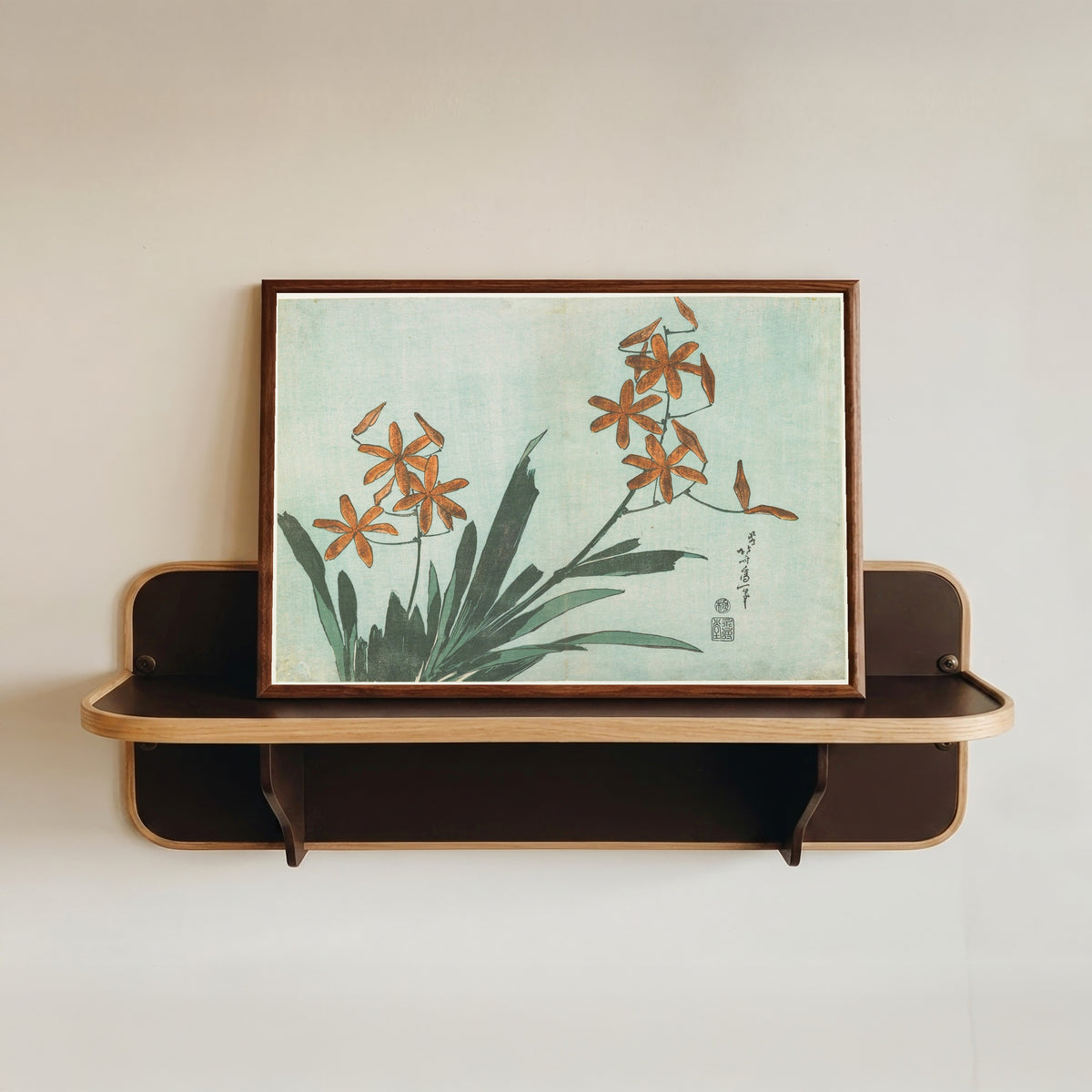 Framed art print of Large Flowers: Leopard Lily by Katsushika Hokusai, in a dark wood frame resting on a wall shelf