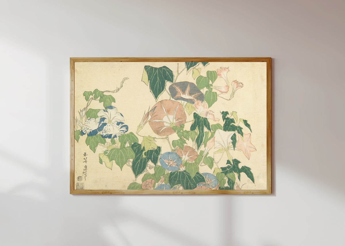 Framed art print of Large Flowers: Morning Glories and Tree-frog by Katsushika Hokusai, in a light wood frame on a sunlit white wall