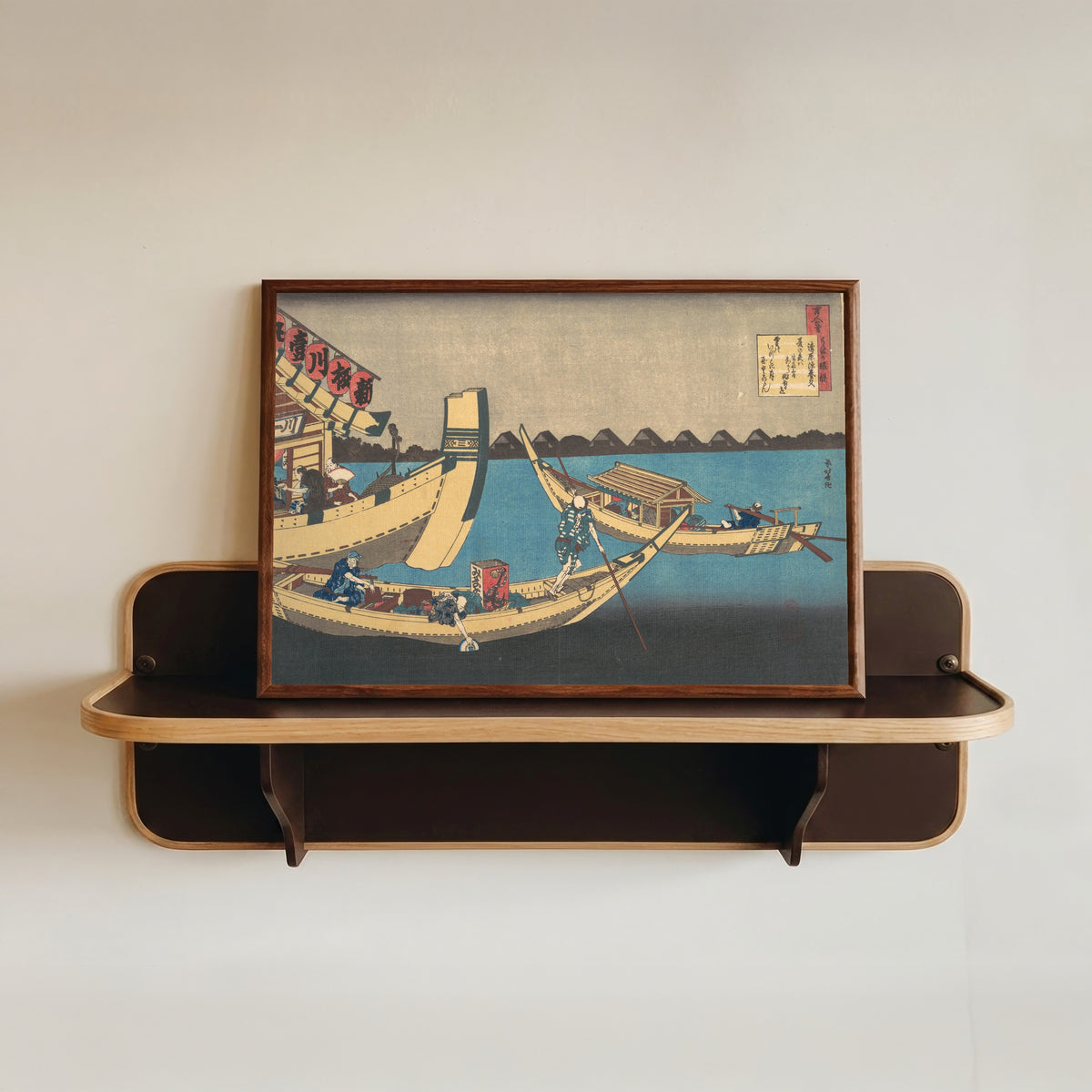 Framed art print of One Hundred Poems Explained by the Nurse: Poem by Kiyohara no Fukayabu by Katsushika Hokusai, in a dark wood frame resting on a wall shelf