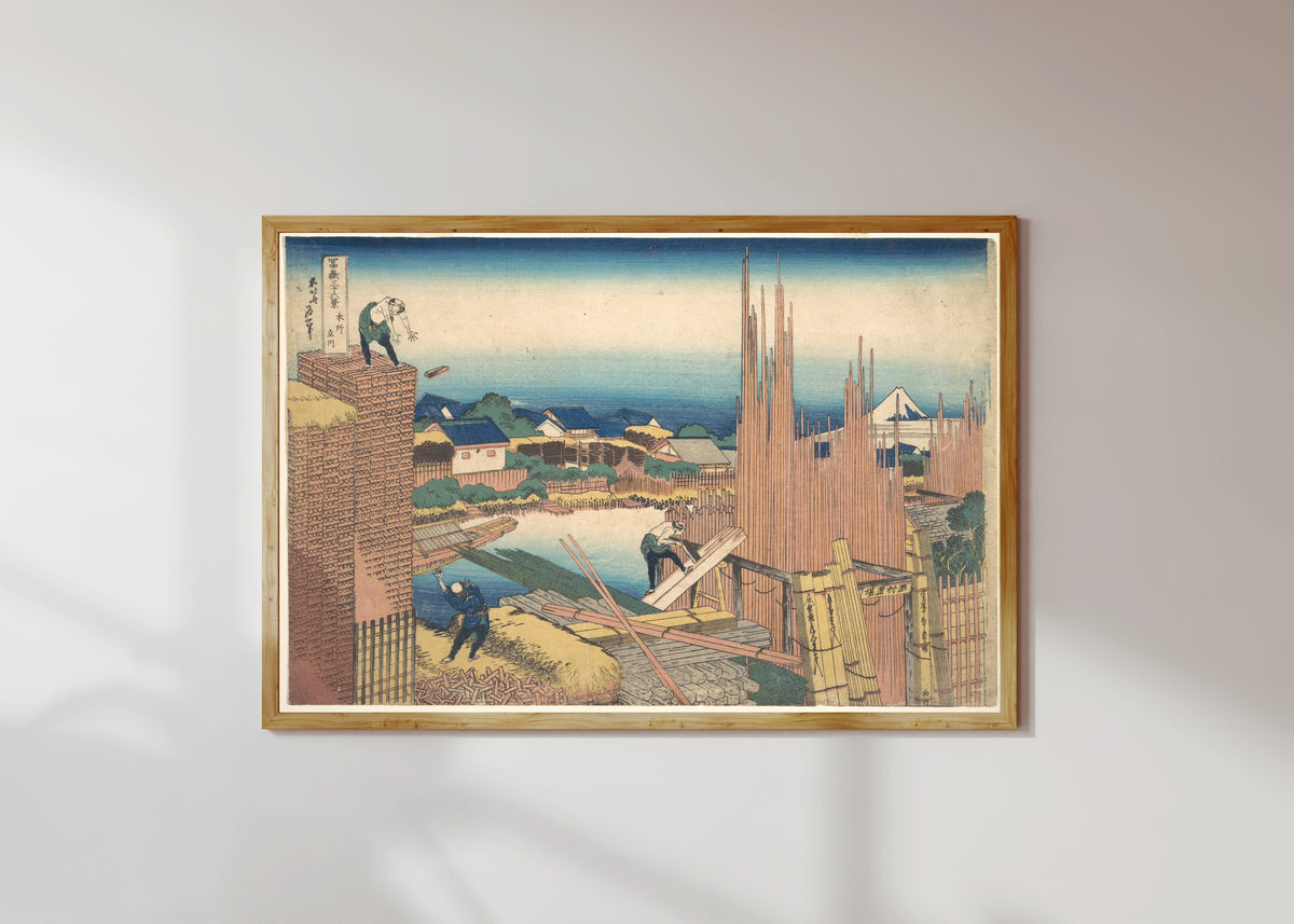 Framed art print of Thirty-six Views of Mount Fuji: Tatekawa River Lumberyard at Honjo by Katsushika Hokusai, in a light wood frame on a sunlit white wall
