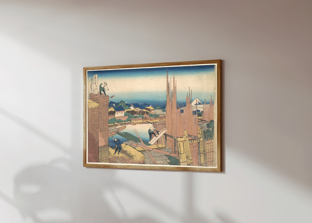 Framed art print of Thirty-six Views of Mount Fuji: Tatekawa River… by Katsushika Hokusai, in a light wood frame on a sunlit white wall, seen at a slight angle