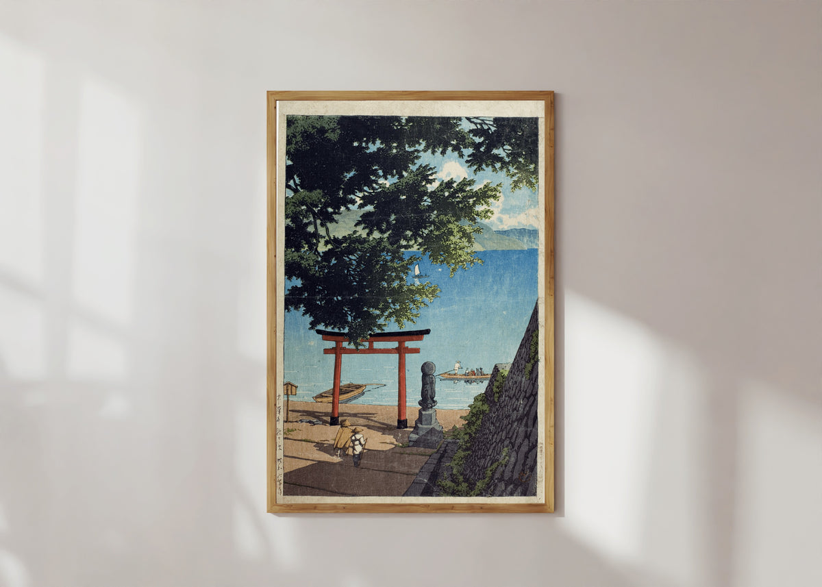 Framed art print of Chuzenji Lake, Utagahama by Kawase Hasui, in a light wood frame on a sunlit white wall