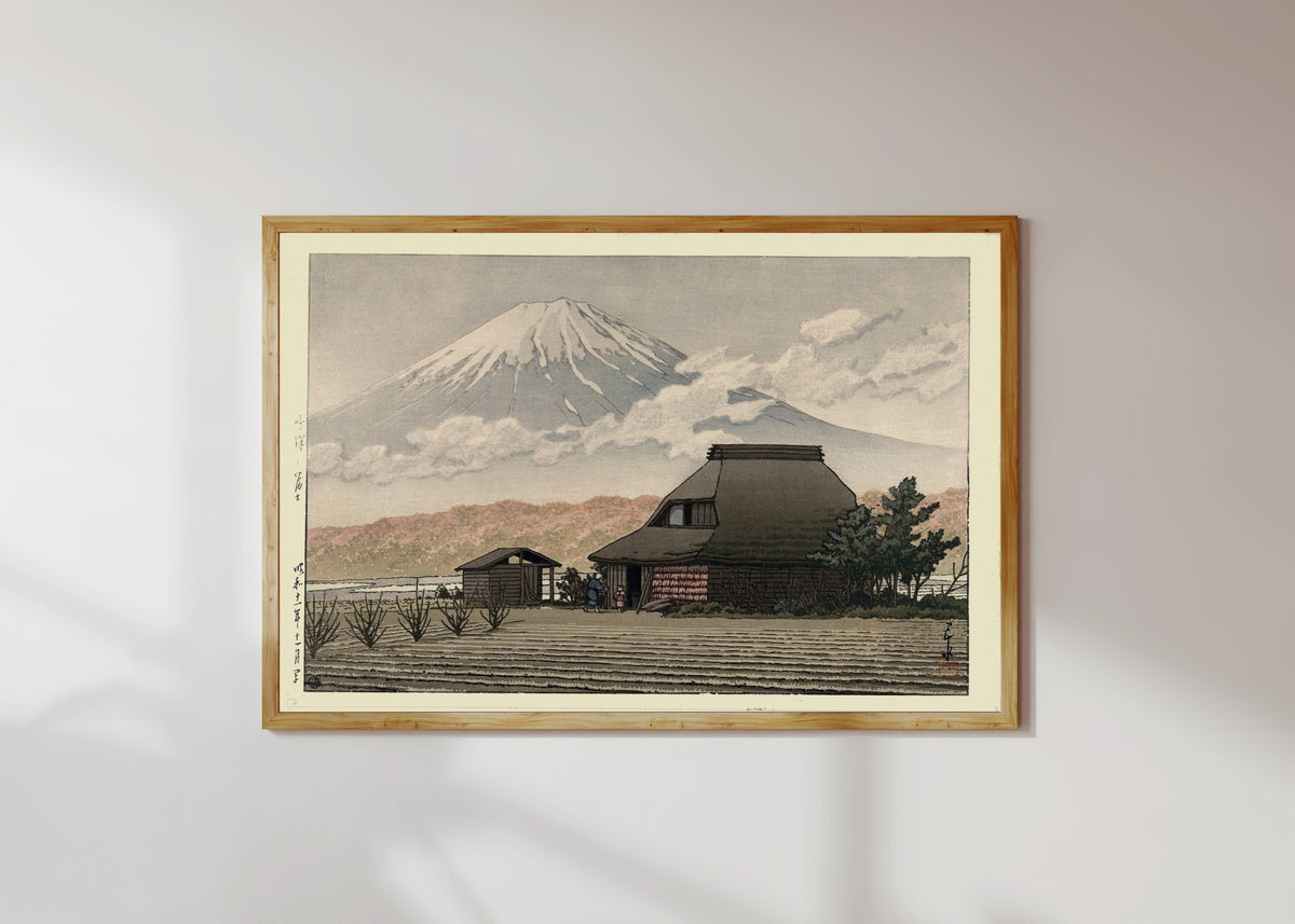 Framed art print of Countryside at Narusawa by Kawase Hasui, in a light wood frame on a sunlit white wall
