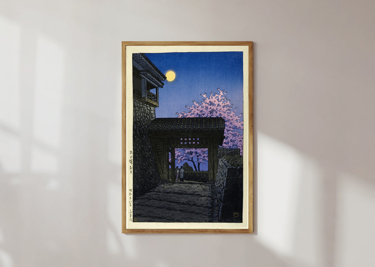 Framed art print of Evening at Matsuyama Castle by Kawase Hasui, in a light wood frame on a sunlit white wall