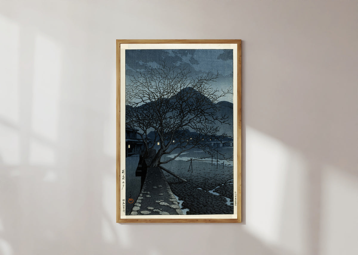 Framed art print of Evening in Beppu by Kawase Hasui, in a light wood frame on a sunlit white wall