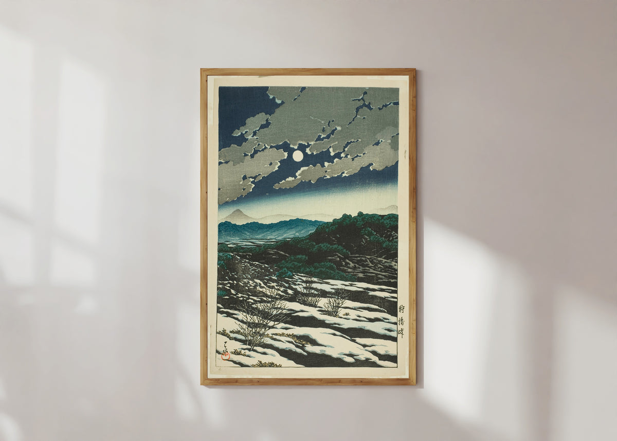 Framed art print of Karikachi Mountain Pass by Kawase Hasui, in a light wood frame on a sunlit white wall