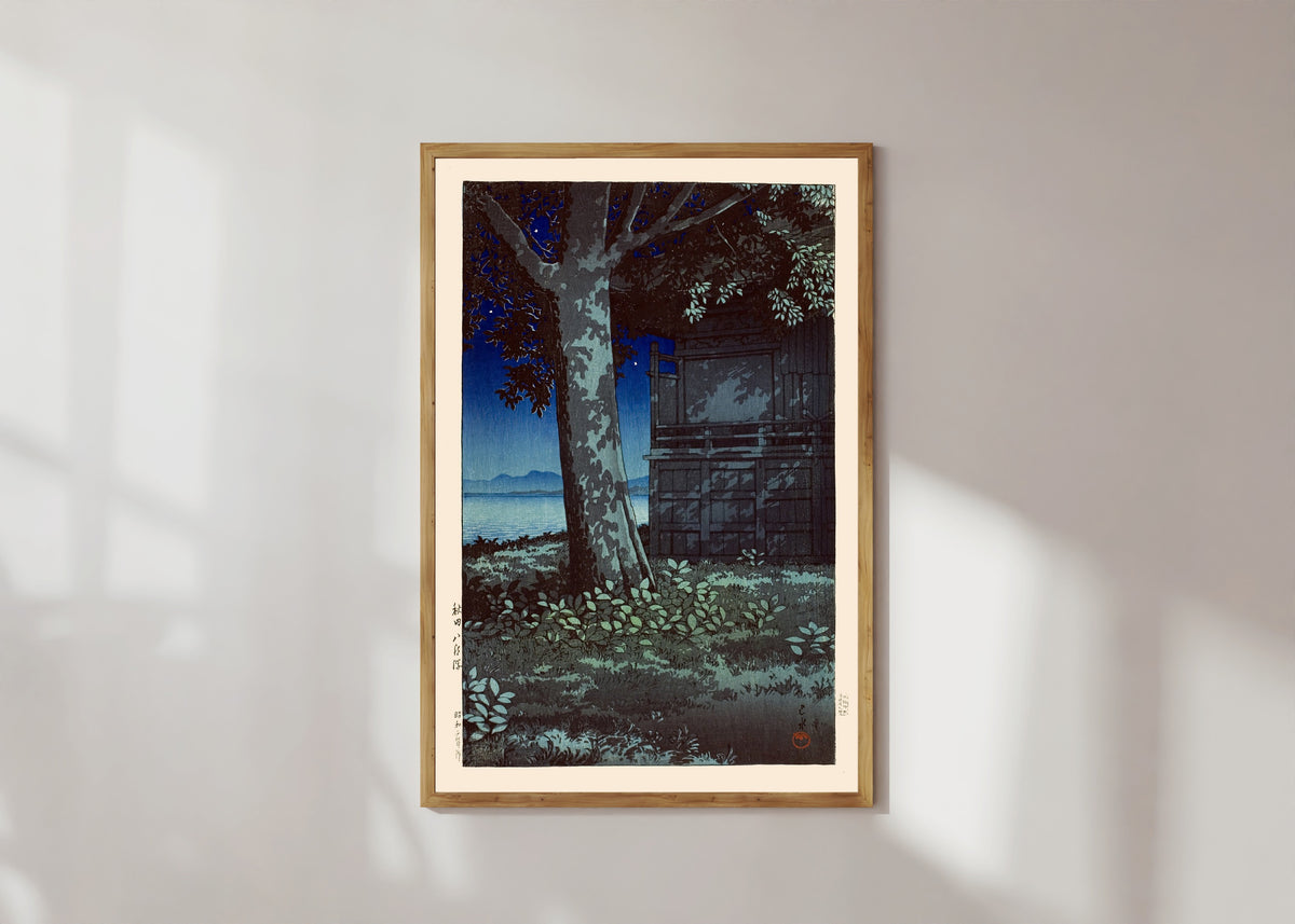 Framed art print of Lake Hachirogata at Night by Kawase Hasui, in a light wood frame on a sunlit white wall