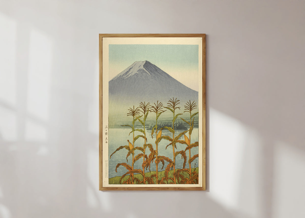 Framed art print of Lake Kawaguchi, Oishi by Kawase Hasui, in a light wood frame on a sunlit white wall
