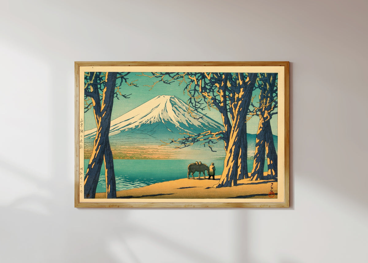 Framed art print of Late Autumn at Lake Yamanaka by Kawase Hasui, in a light wood frame on a sunlit white wall