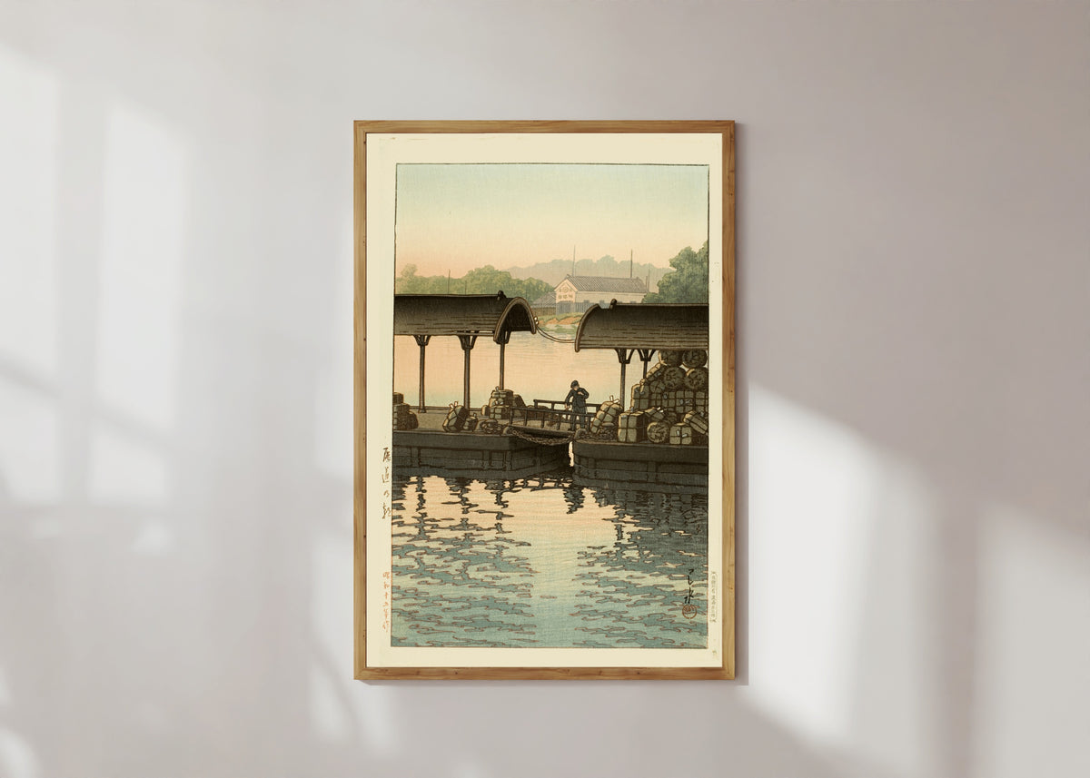 Framed art print of Morning at Onomichi by Kawase Hasui, in a light wood frame on a sunlit white wall