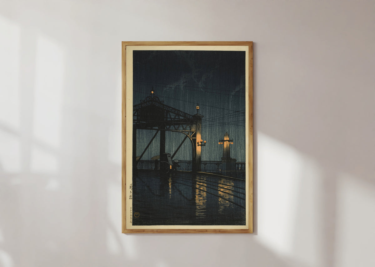 Framed art print of Shin Ohashi Bridge at Night by Kawase Hasui, in a light wood frame on a sunlit white wall