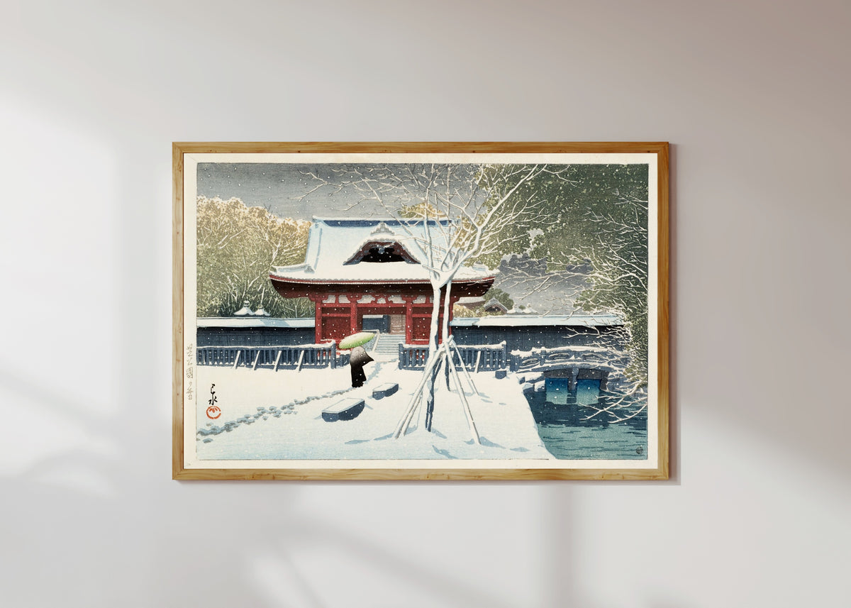 Framed art print of Snow at Shiba Park by Kawase Hasui, in a light wood frame on a sunlit white wall