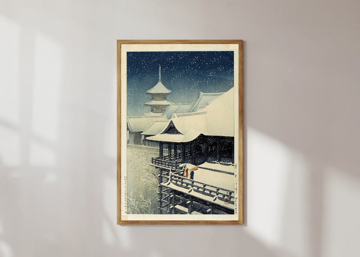 Framed art print of Spring Snow at Kiyomizu Temple, Kyoto by Kawase Hasui, in a light wood frame on a sunlit white wall