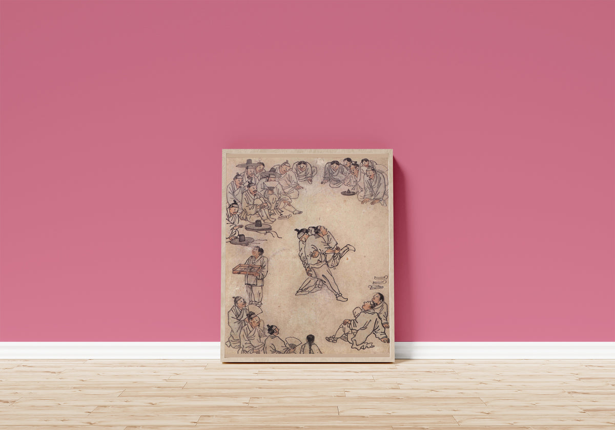 Framed art print of Danwon Genre Painting Album: Wrestling by Kim Hong-do (Danwon), in a light wood frame leaning on a pink wall above a wooden floor